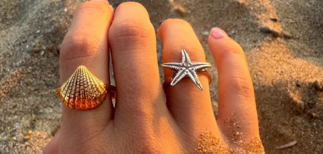 shell and starfish rings on sandy beach in corfu