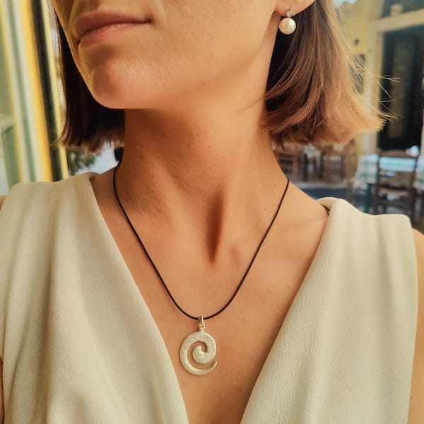 handmade greek spiral pendant crafted in silver inspired by ancient hellenic design at cicero jewelry in corfu